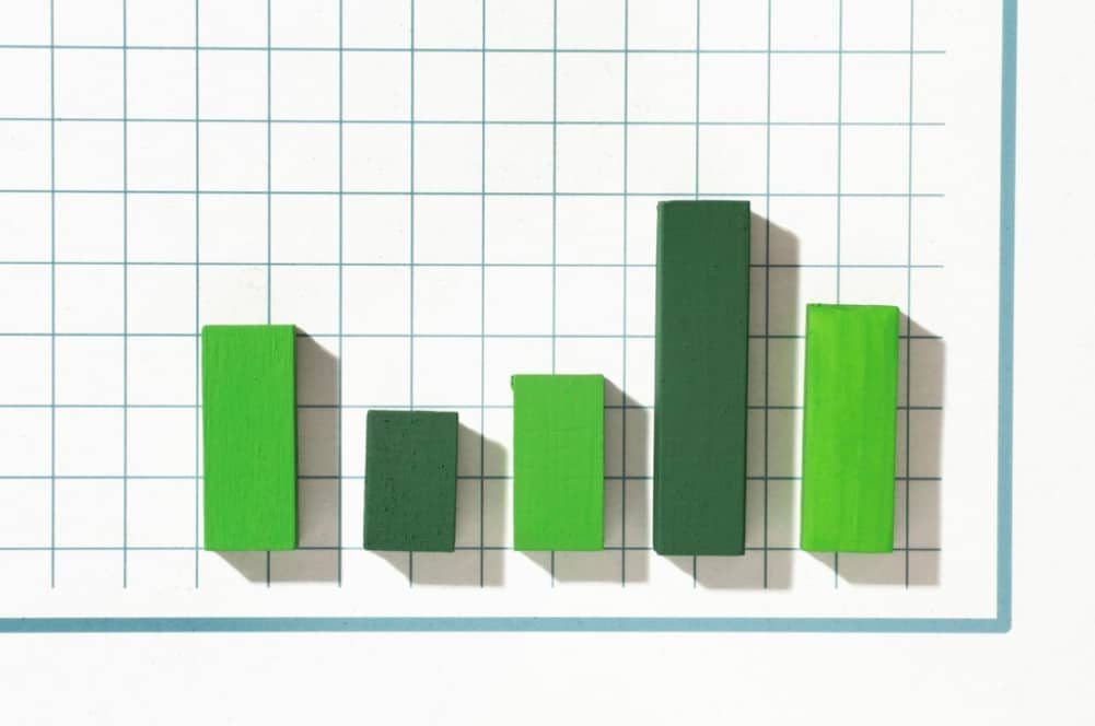 Paper cutout bars on grid paper depicting variable data points