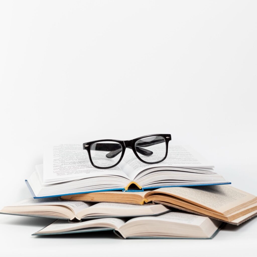 Open books with glasses on it