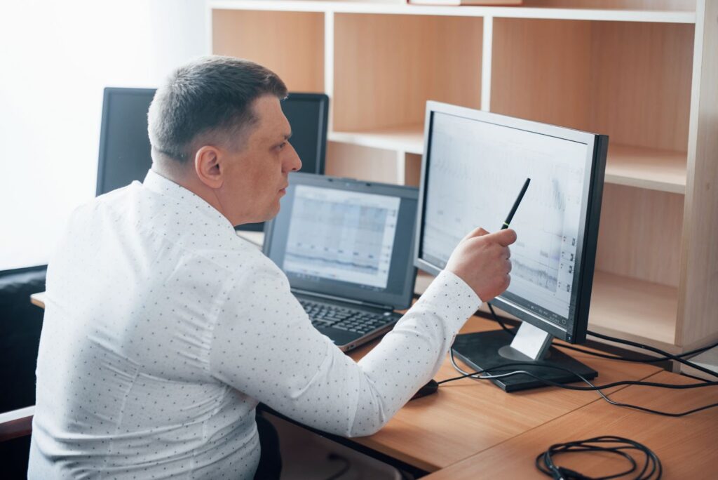 Man in official white shirt working on his computer